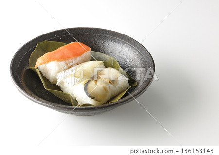 Salmon, sea bream and mackerel persimmon leaf sushi photographed on a white background Salmon, sea bream and mackerel persimmon leaf sushi photographed on a white background 136153143