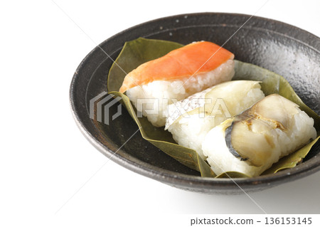 Salmon, sea bream and mackerel persimmon leaf sushi photographed on a white background Salmon, sea bream and mackerel persimmon leaf sushi photographed on a white background 136153145