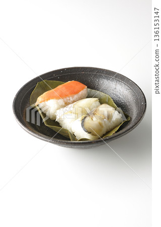 Salmon, sea bream and mackerel persimmon leaf sushi photographed on a white background Salmon, sea bream and mackerel persimmon leaf sushi photographed on a white background 136153147