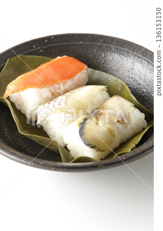 Salmon, sea bream and mackerel persimmon leaf sushi photographed on a white background Salmon, sea bream and mackerel persimmon leaf sushi photographed on a white background 136153150
