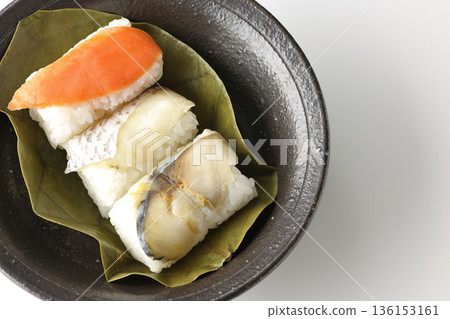 Salmon, sea bream and mackerel persimmon leaf sushi photographed on a white background Salmon, sea bream and mackerel persimmon leaf sushi photographed on a white background 136153161