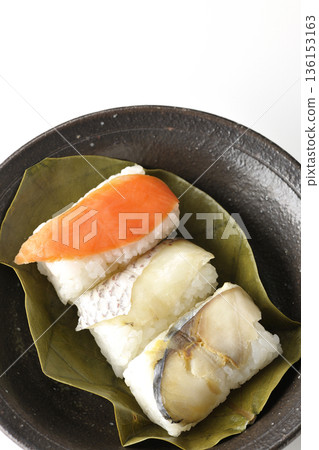 Salmon, sea bream and mackerel persimmon leaf sushi photographed on a white background 136153163