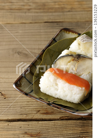 Salmon, sea bream and mackerel sushi wrapped in persimmon leaves Salmon, sea bream and mackerel sushi wrapped in persimmon leaves 136153229