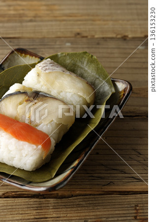 Salmon, sea bream and mackerel sushi wrapped in persimmon leaves Salmon, sea bream and mackerel sushi wrapped in persimmon leaves 136153230