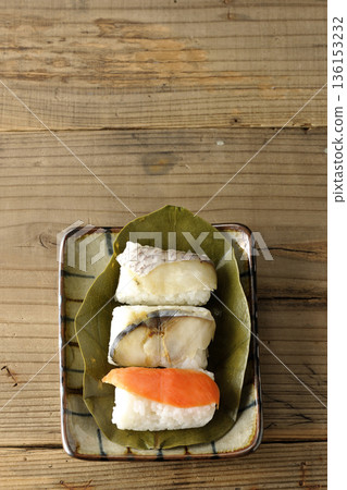 Salmon, sea bream and mackerel sushi wrapped in persimmon leaves Salmon, sea bream and mackerel sushi wrapped in persimmon leaves 136153232
