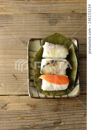 Salmon, sea bream and mackerel sushi wrapped in persimmon leaves Salmon, sea bream and mackerel sushi wrapped in persimmon leaves 136153234