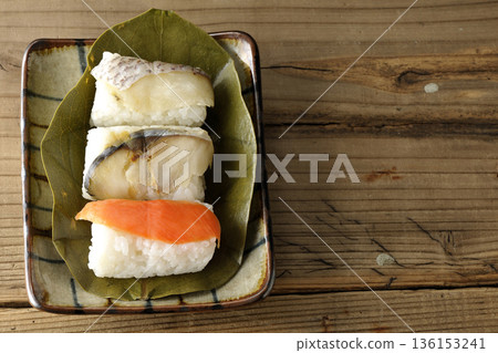 Salmon, sea bream and mackerel sushi wrapped in persimmon leaves Salmon, sea bream and mackerel sushi wrapped in persimmon leaves 136153241