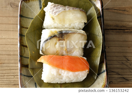 Salmon, sea bream and mackerel sushi wrapped in persimmon leaves Salmon, sea bream and mackerel sushi wrapped in persimmon leaves 136153242