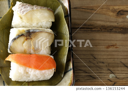 Salmon, sea bream and mackerel sushi wrapped in persimmon leaves Salmon, sea bream and mackerel sushi wrapped in persimmon leaves 136153244