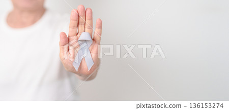 Elderly with Gray ribbon for May Brain Cancer Awareness month and Asthma Awareness, Support life people Survivor. Healthcare and February World cancer day 136153274
