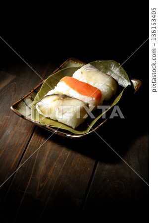 Salmon, sea bream and mackerel sushi wrapped in persimmon leaves Salmon, sea bream and mackerel sushi wrapped in persimmon leaves 136153405