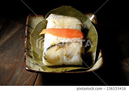 Salmon, sea bream and mackerel sushi wrapped in persimmon leaves Salmon, sea bream and mackerel sushi wrapped in persimmon leaves 136153416