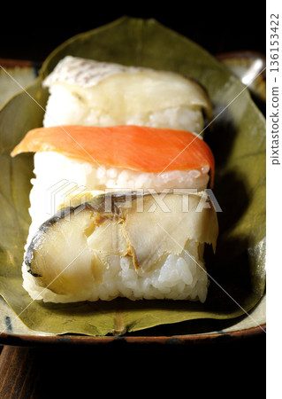 Salmon, sea bream and mackerel sushi wrapped in persimmon leaves Salmon, sea bream and mackerel sushi wrapped in persimmon leaves 136153422