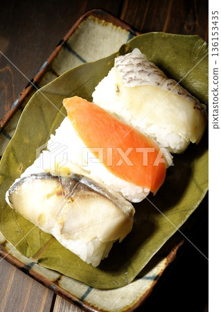Salmon, sea bream and mackerel sushi wrapped in persimmon leaves Salmon, sea bream and mackerel sushi wrapped in persimmon leaves 136153435