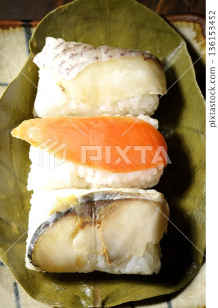 Salmon, sea bream and mackerel sushi wrapped in persimmon leaves Salmon, sea bream and mackerel sushi wrapped in persimmon leaves 136153452
