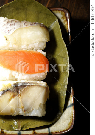 Salmon, sea bream and mackerel sushi wrapped in persimmon leaves Salmon, sea bream and mackerel sushi wrapped in persimmon leaves 136153454
