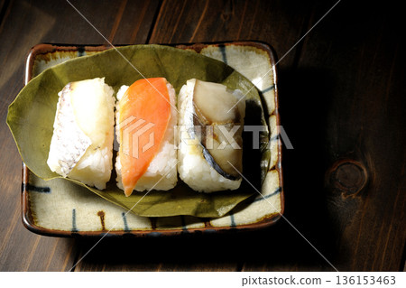 Salmon, sea bream and mackerel sushi wrapped in persimmon leaves Salmon, sea bream and mackerel sushi wrapped in persimmon leaves 136153463