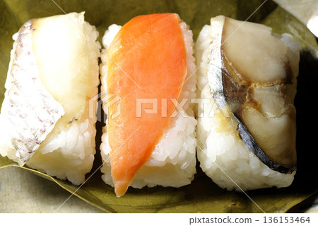 Salmon, sea bream and mackerel sushi wrapped in persimmon leaves Salmon, sea bream and mackerel sushi wrapped in persimmon leaves 136153464