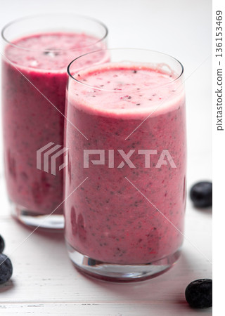 Two glasses of berry smoothie with chia and fresh berries Two glasses of berry smoothie with chia and fresh berries 136153469