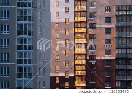 Urban landscape with modern multistory buildings at sunrise. 136153485