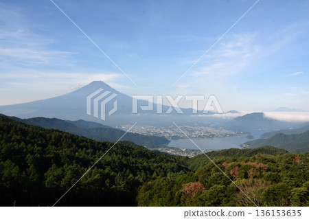 Under the blue sky, the expansive Mount Fuji seen from Nishikawa Forest Road with Lake Kawaguchi filled with water below Under the blue sky, the expansive Mount Fuji seen from Nishikawa Forest Road with Lake Kawaguchi filled with water below 136153635