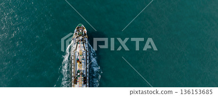 Aerial view oil tanker ship on sea, Oil tanker ship top view, Logistic and maritime transportation of petroleum petrochemical supply chain, Oil tanker ship traveling sailing the sea. Aerial view oil tanker ship on sea, Oil tanker ship top view, Logistic and maritime transportation of petroleum petrochemical supply chain, Oil tanker ship traveling sailing the sea. 136153685