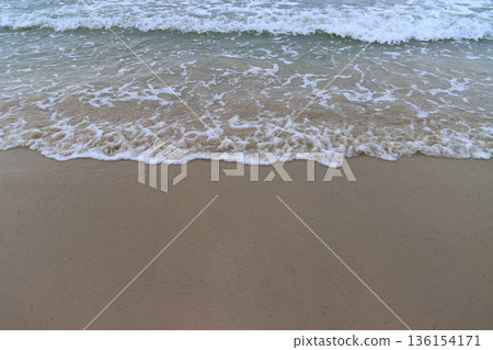 Slow waves moving in and out on the shore Slow waves moving in and out on the shore 136154171