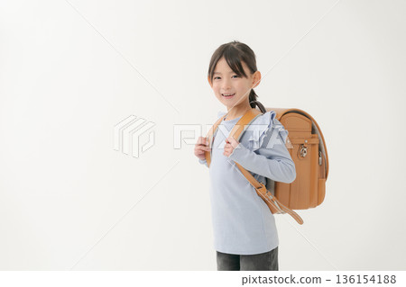 Girls carrying a school bag 136154188