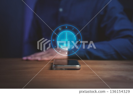 A glowing digital clock icon showing 24/7 above a smartphone on a wooden table, symbolizing nonstop service, customer support, online business availability, and modern digital connectivity. A glowing digital clock icon showing 24/7 above a smartphone on a wooden table, symbolizing nonstop service, customer support, online business availability, and modern digital connectivity. 136154329
