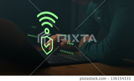 Man using a laptop computer with Wi-Fi security icon and checkmark, symbolizing safe internet connection, encrypted access, cybersecurity, and password protection for online data. 136154333