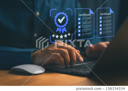 Person using a laptop with glowing digital icons of certificates, checklists, and a quality badge. Symbolizing certification, compliance, digital credentials, and professional standards verification. 136154334