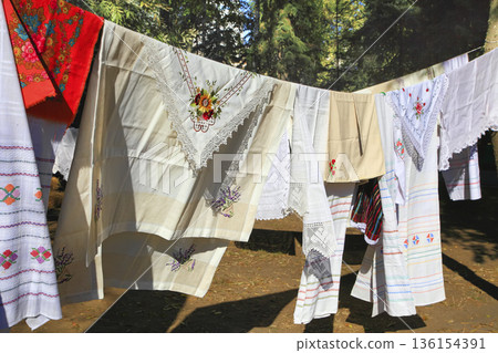 Linen tablecloths, towels, napkins decorated with embroidery and lace. Linen tablecloths, towels, napkins decorated with embroidery and lace. 136154391