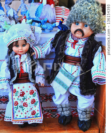 Chisinau, Moldova - October 15,2022: City Day. The dolls are dressed in national Moldavian clothes. Chisinau, Moldova - October 15,2022: City Day. The dolls are dressed in national Moldavian clothes. 136154393