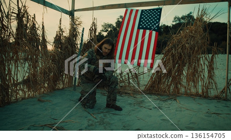 Radio call for help from an American soldier in a desert hut new the flag 136154705