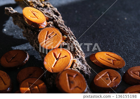 handmade wooden runes close-up on dark background 136155198