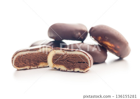 Dark chocolate truffles in the shape of coffee beans isolated on white background. 136155281