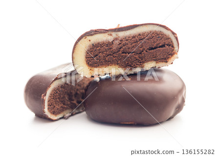 Dark chocolate truffles in the shape of coffee beans isolated on white background. Dark chocolate truffles in the shape of coffee beans isolated on white background. 136155282