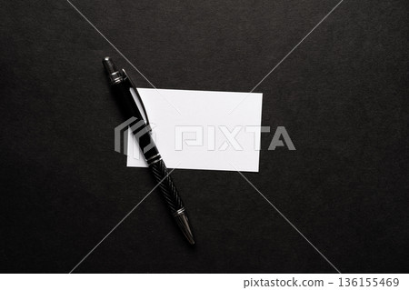 Ballpoint pen and notepad on a black background 136155469