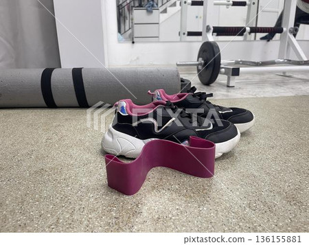 elastic resistance bands near the snikers in sport hall 136155881