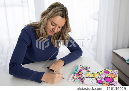Woman Practices Neurography, Drawing on Paper at Home for Relaxation and Therapy Woman Practices Neurography, Drawing on Paper at Home for Relaxation and Therapy 136156029