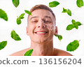 Young man with flying mint leaves, concept of freshness, men's skin care and purity. 136156204