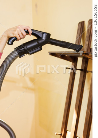 Woman cleaning dust on hanger Woman cleaning dust on hanger 136156558