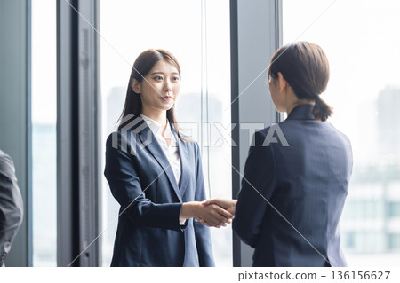 Business woman shaking hands Business woman shaking hands 136156627