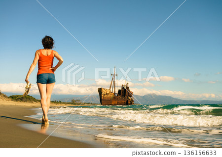 Tourist woman on beach enjoying vacation Tourist woman on beach enjoying vacation 136156633