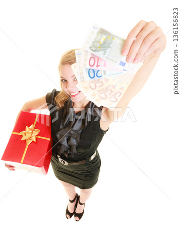 Woman with gift box and euro currency money banknotes. Woman with gift box and euro currency money banknotes. 136156823