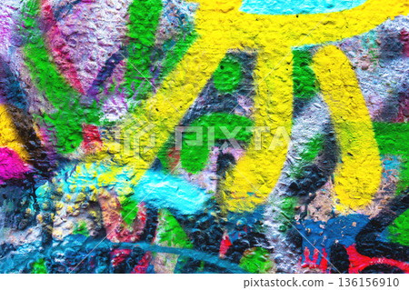 Colorful Abstract Graffiti Wall Texture with Yellow, Green, Blue, Pink Spray Paint in Urban Street Style Colorful Abstract Graffiti Wall Texture with Yellow, Green, Blue, Pink Spray Paint in Urban Street Style 136156910