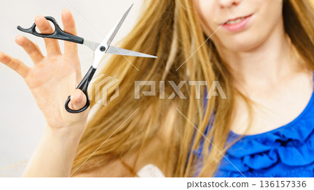 Woman with scissors ready to hair cutting Woman with scissors ready to hair cutting 136157336