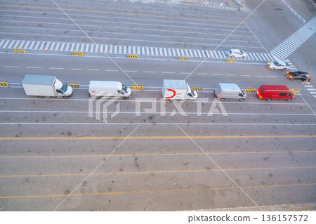 Top view of vehicles lined up at port terminal. Transportation, logistics, travel flow and maritime infrastructure concept 136157572