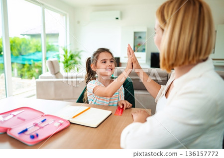 Joyful learning moment between a child and mentor 136157772