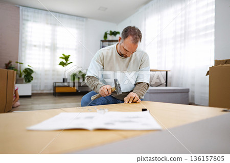 Creating a cozy home environment with careful assembly of furniture 136157805